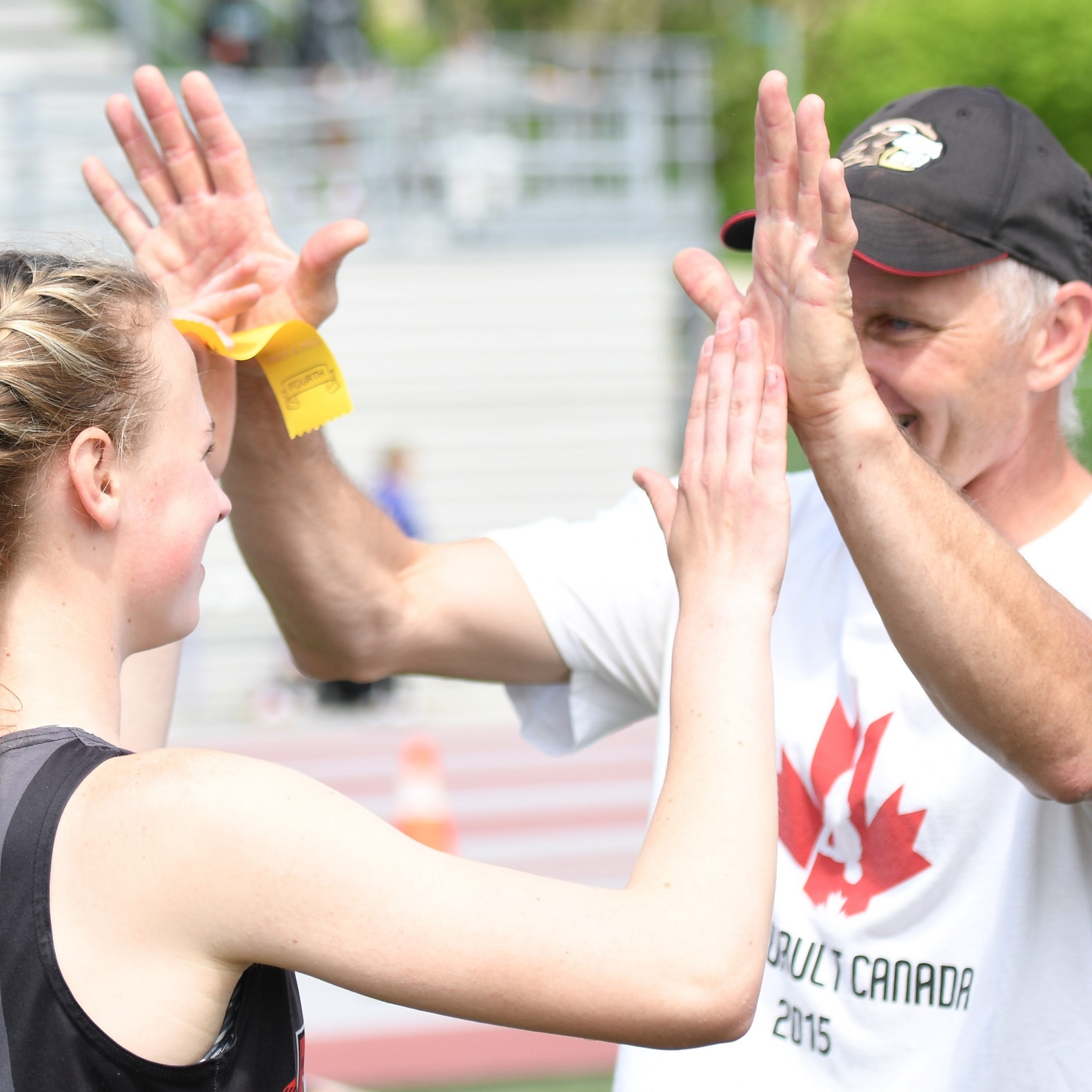 Quance high fives pole vault coach