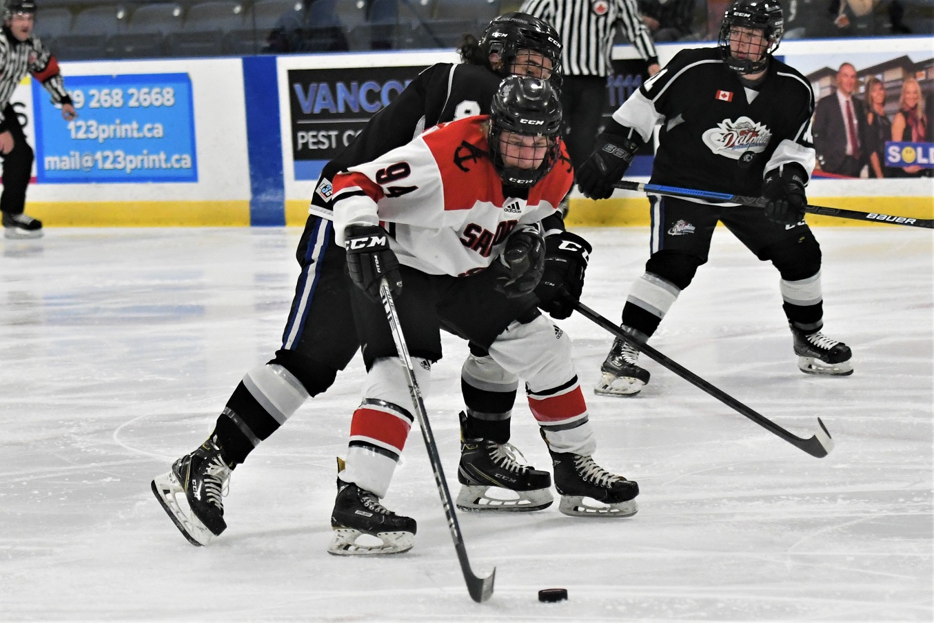 Port Stanley Sailor Hunter Gilchrist fends off Dorchester Dolphin Quinn Wenger during Provincial Junior Hockey at Dorchester. The Dolphins won 4-1. <i> (photo / Rob J. Ross) </i> action