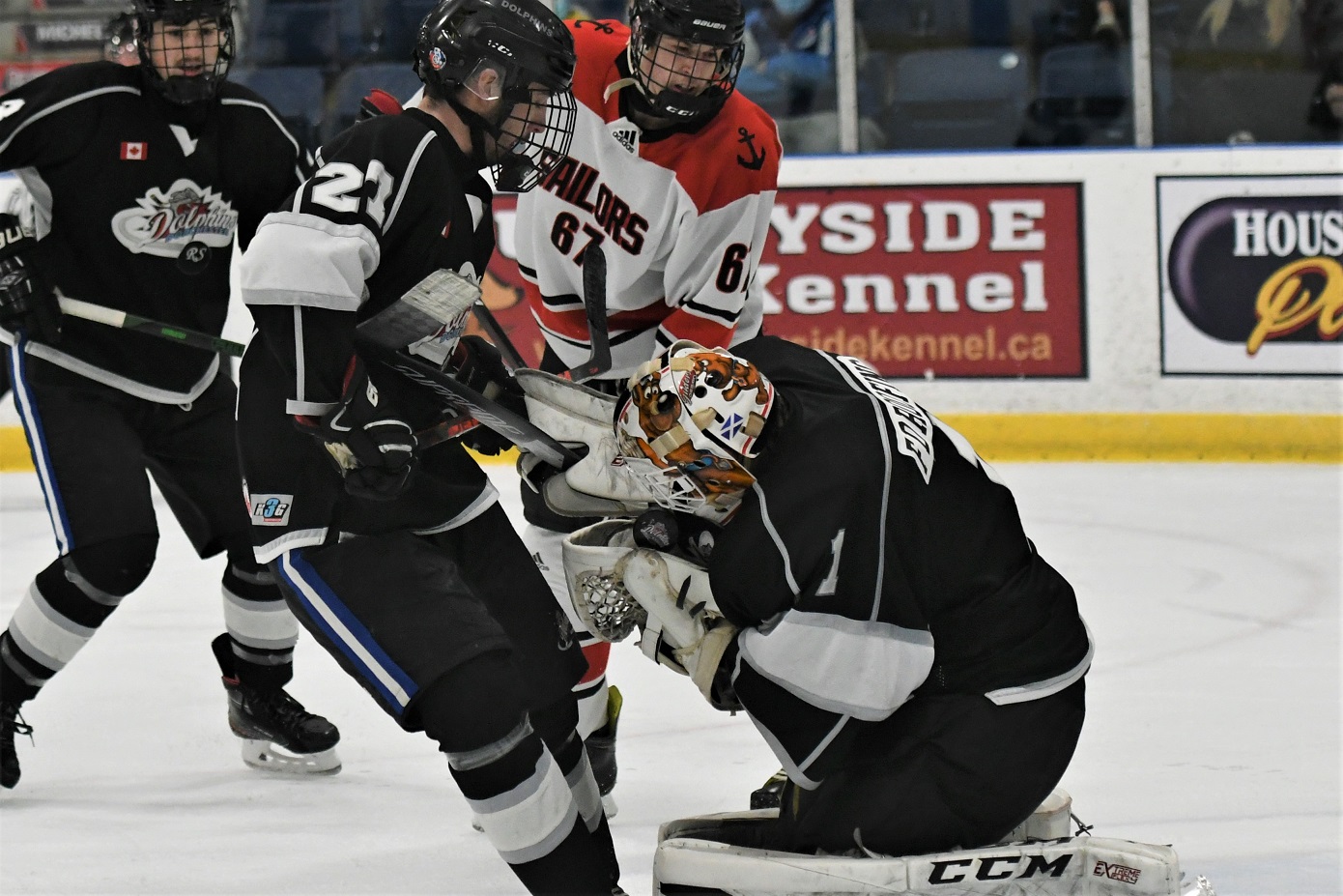 Dorchester Dolphins' goalie Liam McCarthy snags the puck in his glove with Port Stanley Sailor Andrew Gyners (67) on the doorstep during Provincial Junior Hockey at Dorchester. The Dolphins won 4-1. <i> (photo / Rob J. Ross) </i> action