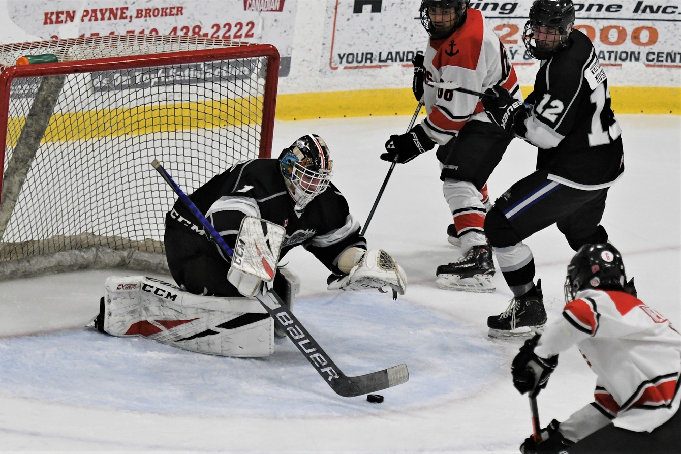 Dorchester Dolphins' goalie Liam McCarthy pounces on the puck a net against the Port Stanley Sailors during Provincial Junior Hockey at Dorchester. The Dolphins won 4-1. <i> (photo / Rob J. Ross) </i> action